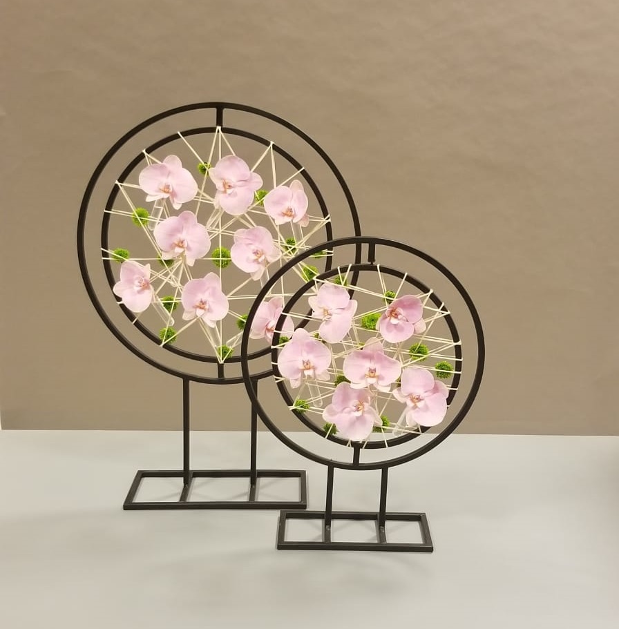 floral design with pink orchids in round frames