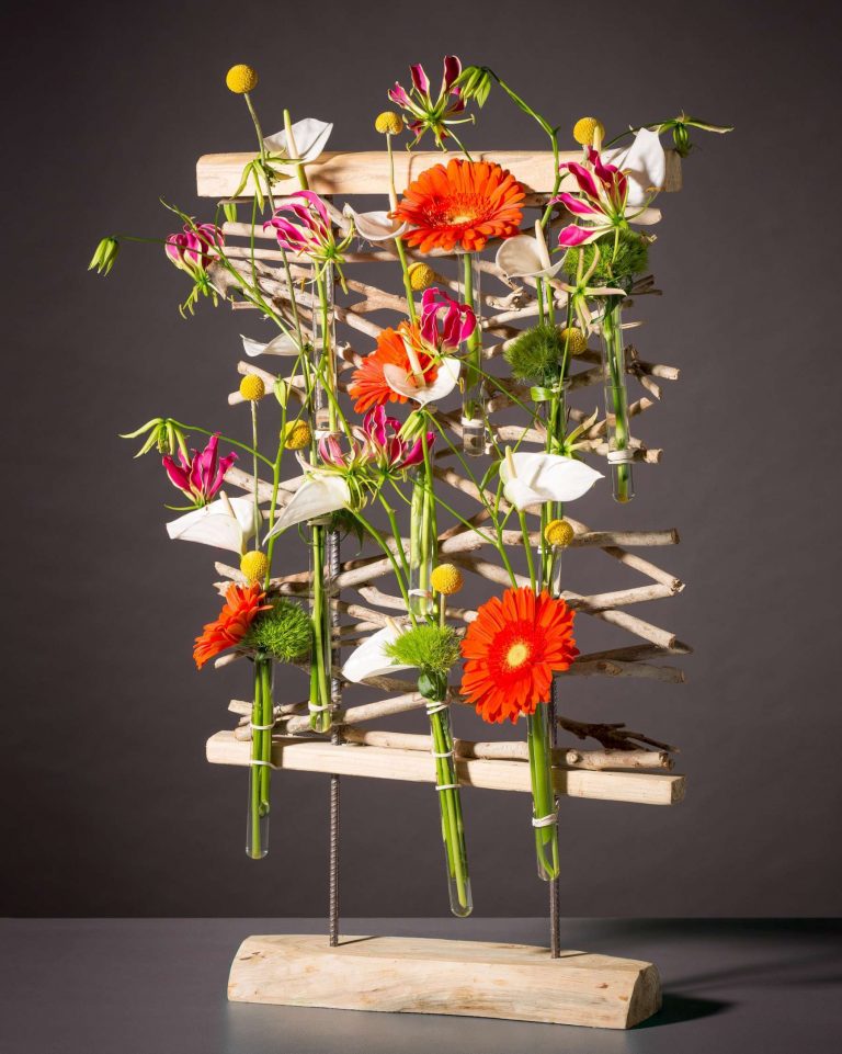 wooden flower frame with gerbera daisies, anthurium and greenery